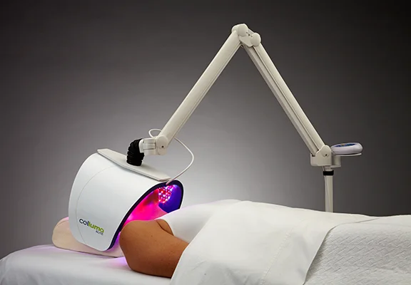 Functional Medicine Toms River NJ Celluma Red Light on Face A patient laying down while a celluma light shines red light on their face for acne treatment